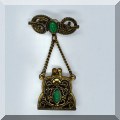 J098. Brass look scroll pin with drop purse pendant. - $14 